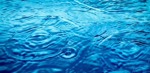 Water wavy surface top view. Water ripples in blue color. Useful graphic banner 