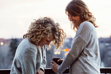 Cheerful businesswomen standing in hotel balcony
