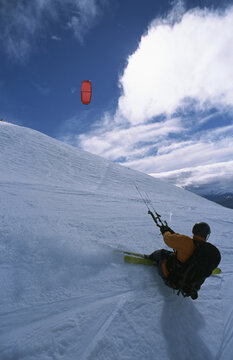 Snow Kiter skids along a snowy mountain.