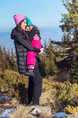 Happy Woman and  Kid in the Winter Mountain   .Family Time in the Nature 