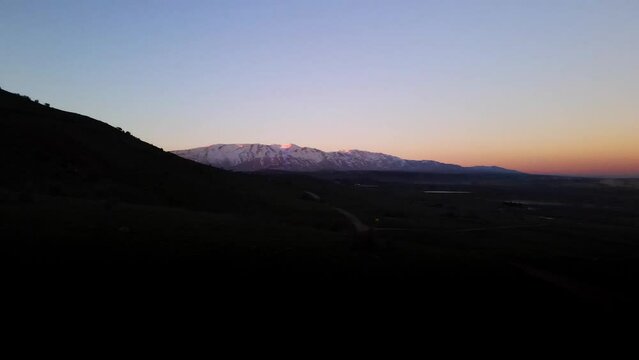 Valley of Tears aerial view flyover at dusk, Mount Hermon in background, Israel