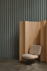 Modern interior scene with Scandinavian sheepskin club chair, wooden screen against the  wall with metal vertical stripes. Copy space. Creative background.