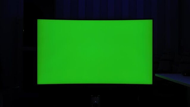 422 10 bit static shot, curved tv green screen at night in a dark room with ambient lighting