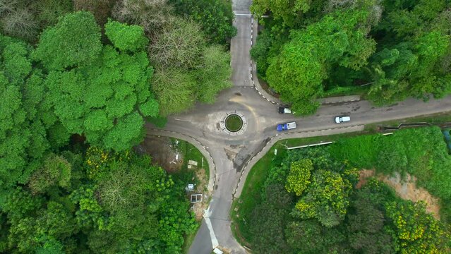 Mahe Seychelles drone moving down towards roundabout. passing vehicles