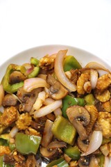 Fresh stir fried or sauteed vegetables. broccoli, zucchini, green and red peppers, mushrooms, onions, baby corn. colorful veggies in a white plate. Weightloss journey. Fitness concept. Healthy life.