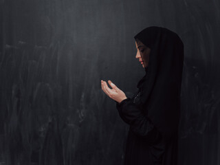 Portrait of young Muslim woman making dua