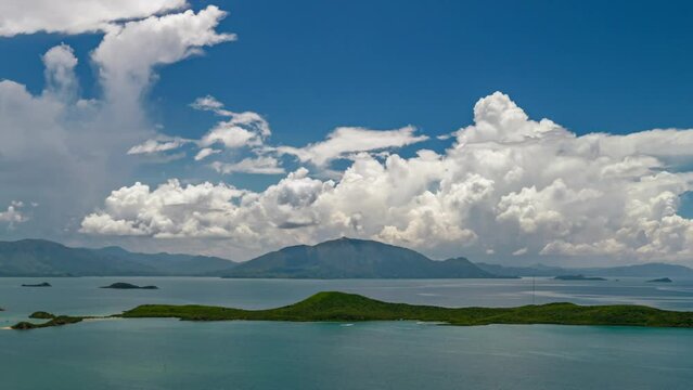 Puffy clouds billow above Mont Dore peak near Noumea, New Caledonia. Aerial Timelapse.