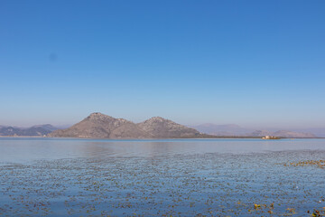 Panoramic view of ruins on Island Grmozur in Lake Skadar National Park in autumn seen from Godinje, Bar, Montenegro, Balkans, Europe. Travel destination in Dinaric Alps near the Albanian border