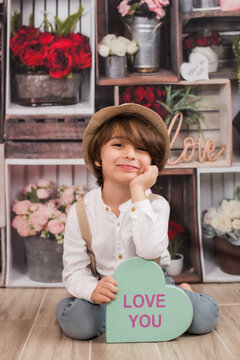 cute little boy holding a love heart sign for valentines day stock image 