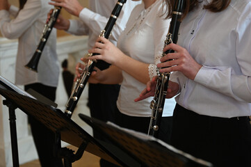 orchestra musicians playing flutes close-up