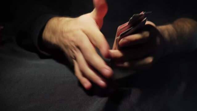 Poker table during the game. The player holds the cards in his hands. Chips and cards on the table. Gambling theme.