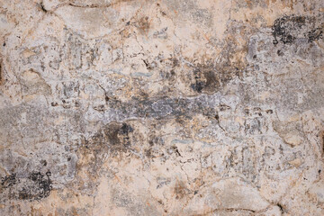 Damaged dirty plaster wall with rough texture and stain