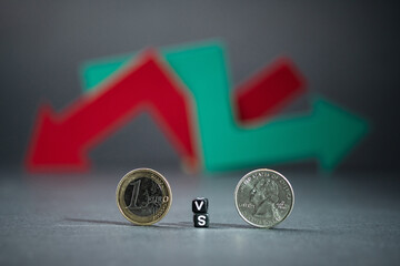 Euro versus dollar on black background. Red and green arrow intertwined showing indecision in the stock market