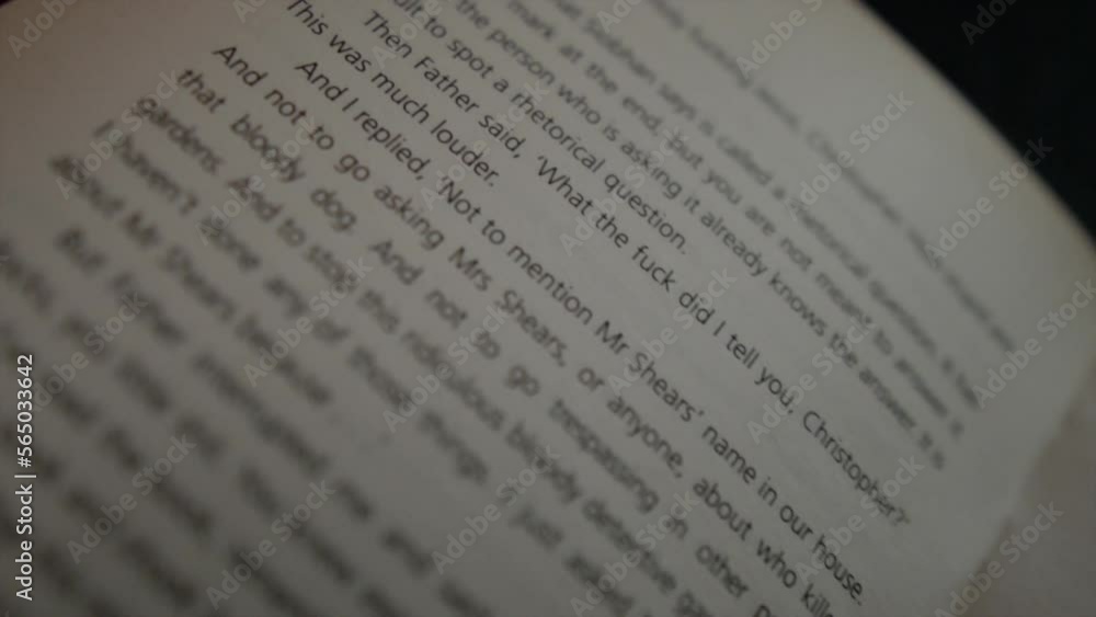 Poster panning shot across an open page of a book highlighting different lines of text giving the effect of