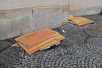 carelessly disposed garbage cardboard in the city