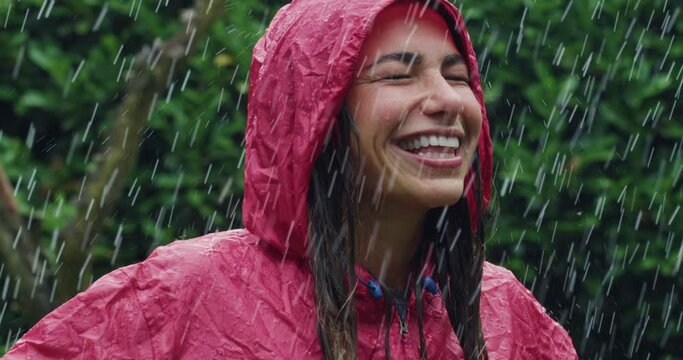Portrait of a Happy Woman in a Red Raincoat Laughing and Enjoying Being Under the Rain. Female Adult Grateful for the Blessing of Water and Nature, Surrounded by Trees. Autumn Joy Concept 