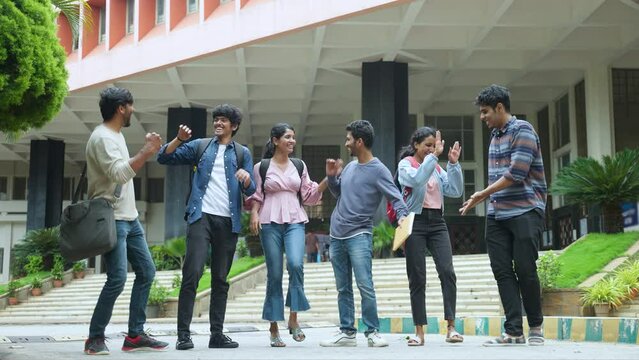 Cheerful group of graduated students jumping at college campus after completion of degree class or positive results - concept of freedom, aspirations and successful