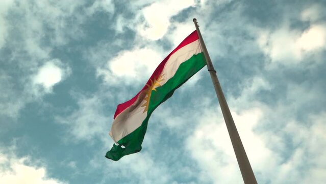 Kurdistan national state flag waving on blu sky, Flag of Kurdistan, used in Iraqi Kurdistan.
