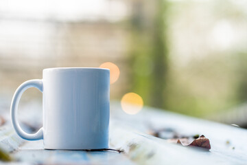 Image of an coffee mug on the top of a roof with blurred out background on the back, coffee mug mockup image