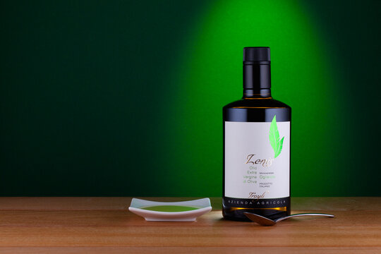 Bottle of Lenis Extra Virgin Olive Oil on the green background.