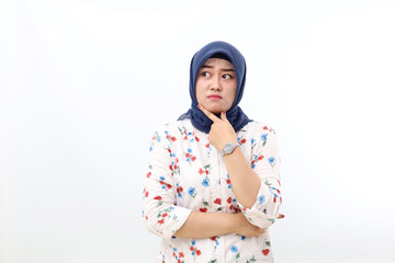 Asian veiled woman standing while thinking something and looking sideways. Isolated on white