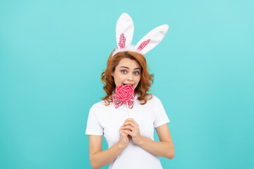 happy easter girl wear bunny ears hold yummy lollipop