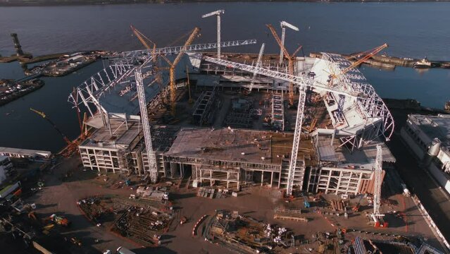 Aerial slow orbit of Everton Football Club new stadium under construction