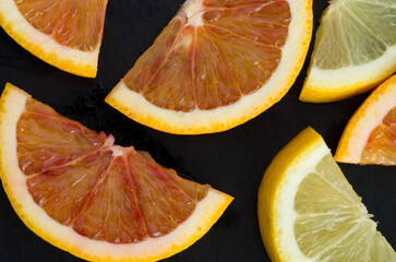 Macro Image of Blood Orange and Lemon Slices on Black Background