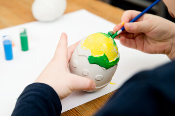 Easter egg made of plaster. Montessori implement to stimulate creativity, to keep focus on the task, stress relief. Preschool activities at home.
