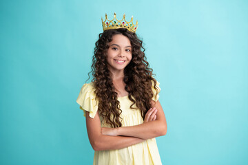 Teen child in queen crown isolated on blue background. Princess girl in tiara. Teenage girl wear...