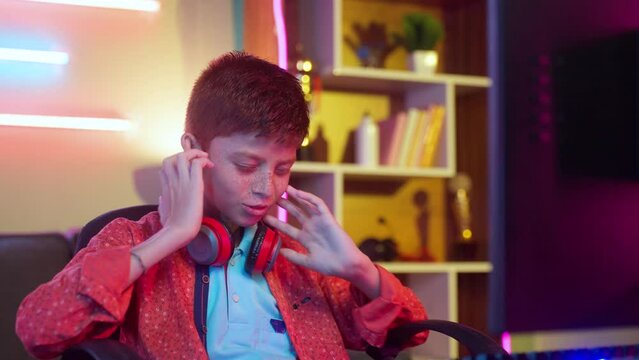Teenager kid due to losing while playing online video game on computer at home - concept of cyberspace, competition and tournament