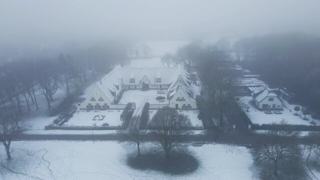 Aerial of beautiful old farm building in a rural area in winter