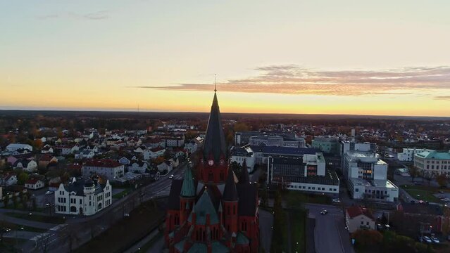 Vastervik, Sweden sunset cityscape downtown area - aerial pull back reveal