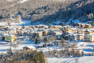 Beautiful winter mountain snow-covered landscape on sunny day. Andalo village, Adamello Brenta...