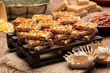 Pé de Moleque or Pé de Menino is a typical peanut candy from Festa Junina. Traditional Brazilian food on a mini wooden pallet, a sweet June party