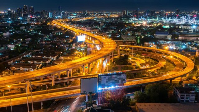 time lapse of aerial view automobile car vehicle drive on highway or motorway in business downtown at night with curve road in motorway or express way with skyscrapper view