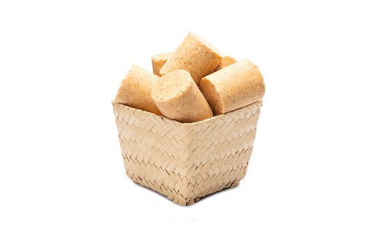 Pa&ccedil;oca also known as "Pa&ccedil;oquita". Typical sweet from Festa Junina (June Party) in Brazil, made from peanuts. Inside a straw basket isolated on a white background for cutting
