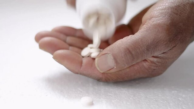 pills from a bottle being poured in hand with white background stock video stock footage
