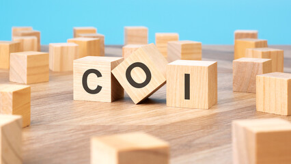 COI written on wooden cube, business concept