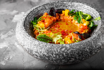 Raw salmon fish tartare with mango and caviar