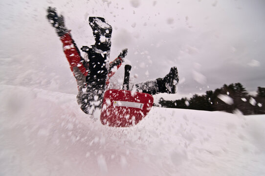 Boy crashing while sledding.