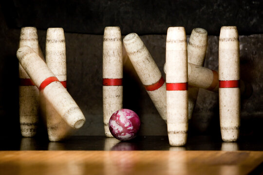 Candle pins fly as the ball strikes them, Gardiner, Maine