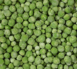 Green raw frozen peas background closed up