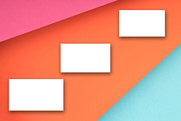 Business card blank over colorful background. Copy space for text. Top view.Business card blank over colorful abstract background. Corporate stationery branding mock-up. Copy space for text. Top view.