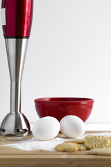 Shortbread Biscuit, Eggs, Red Mixer and Bowl on Wood Table
