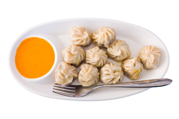 Steam-cooked momos with sauce, Nepalese Traditional Dish Momo. Authentic Cuisine in Nepal momo on a white background.
