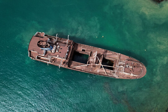 Aerial drone point of view from above to the abandoned ship after shipwreck on the shore between Arrecife and Costa Teguise of Lanzarote Island. Spain. Travel destinations concept