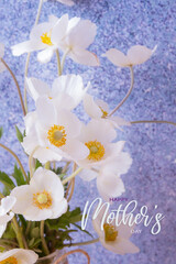 Happy Mothers day greeting card with white anemones flowers, vertical format
