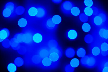 Blue blurred holiday lights. Defocusing.
