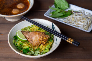 
noodles on wooden background, Asian junk food concept, vegetables udon noodles, bowl on a wood table with copy space, Space for text, Soba noodles
